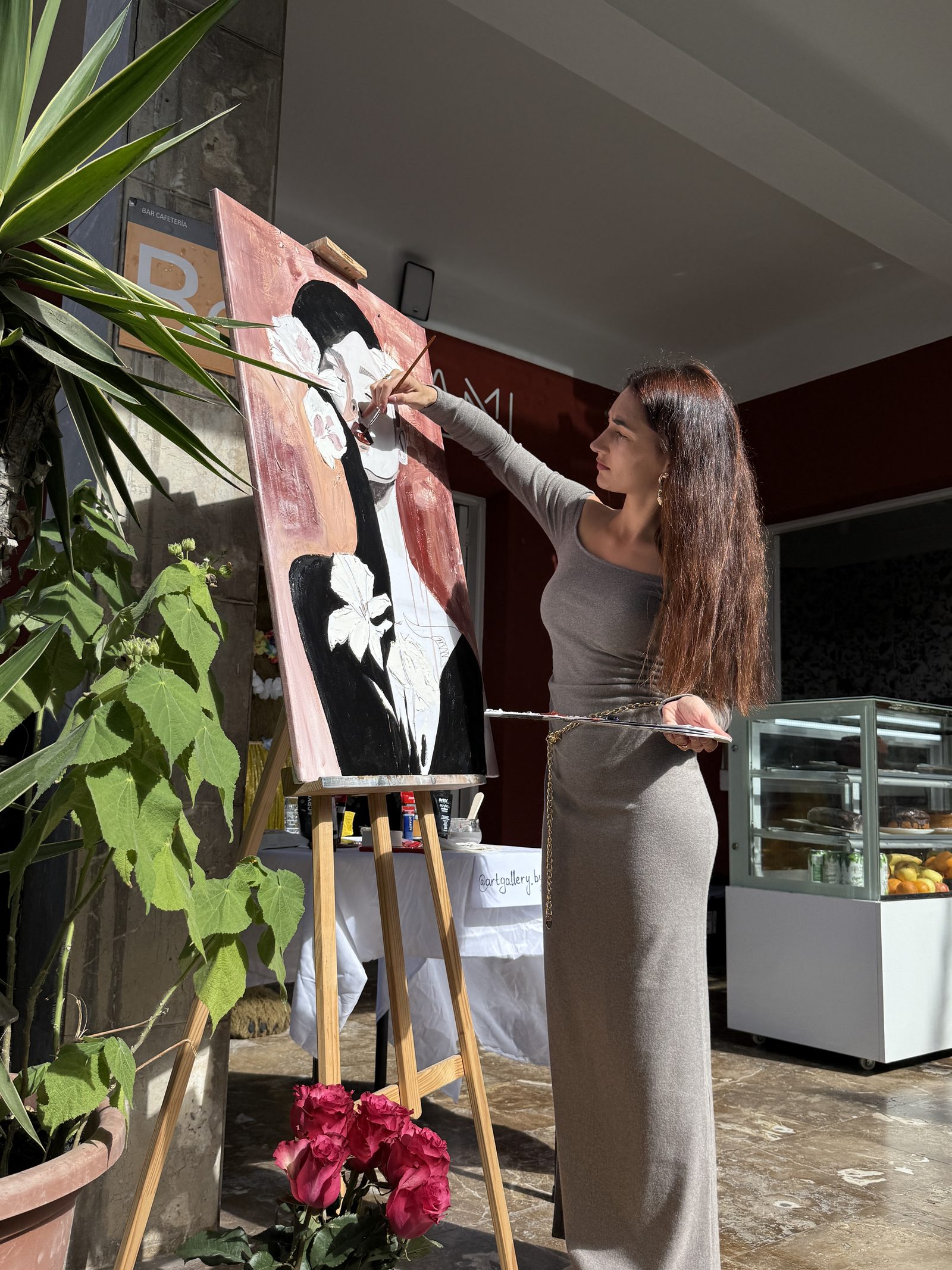 Valeria Dumanova painting at her easel